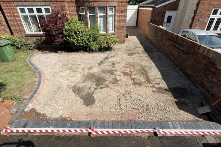 Compacted hardcore sub-base with the black block paving border installed, Rhiwbina, Cardiff 
